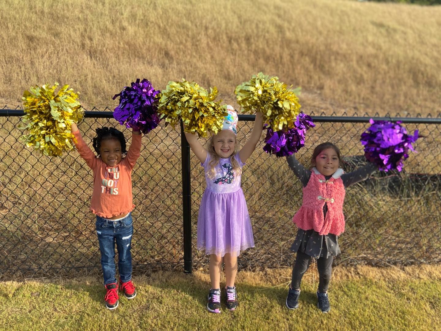 Three students cheering Three students cheering